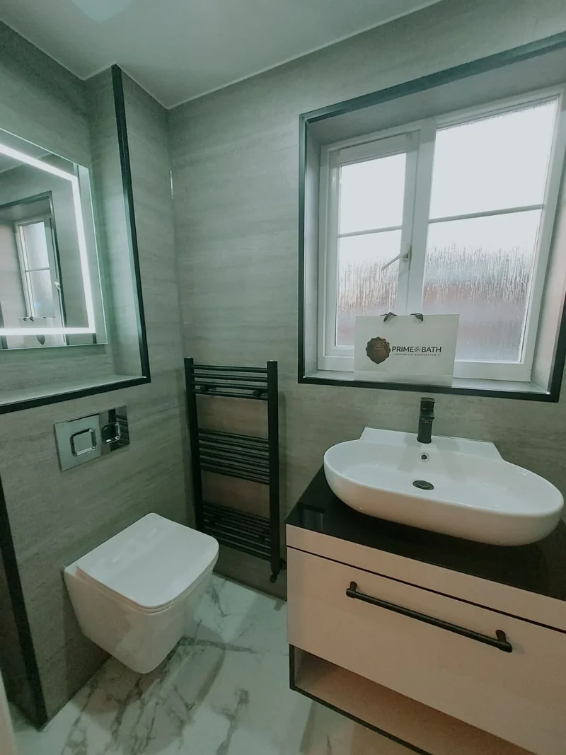 Completed bathroom with grey wall panels, vanity and walk-in shower
