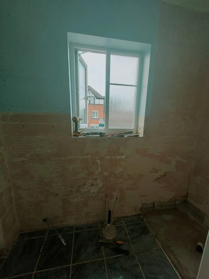Bathroom before renovation with unfinished walls and floor